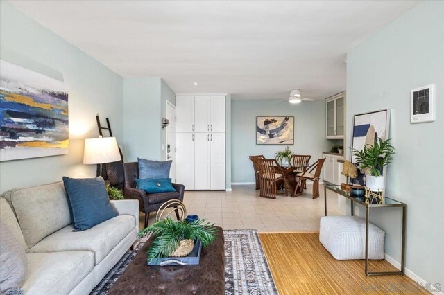 living room with ceiling fan and light hardwood / wood-style flooring