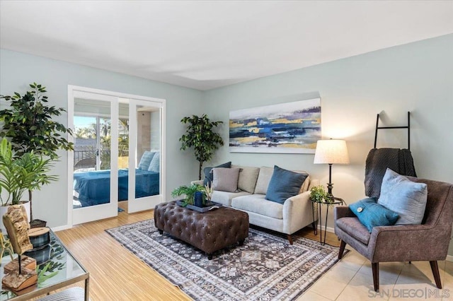 living room with french doors and light hardwood / wood-style flooring