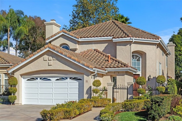 mediterranean / spanish home with a garage