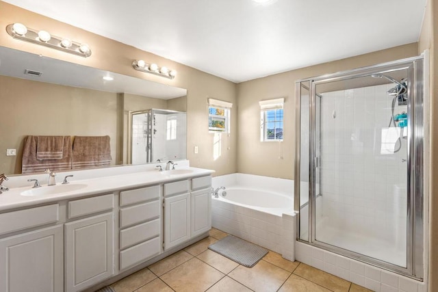 bathroom with shower with separate bathtub, vanity, and tile patterned floors