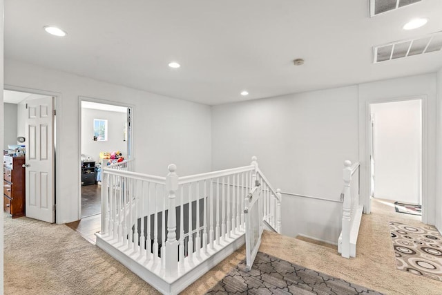 hall featuring light colored carpet