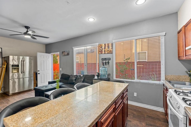 kitchen with ceiling fan, sink, stainless steel fridge with ice dispenser, dark hardwood / wood-style floors, and white stove