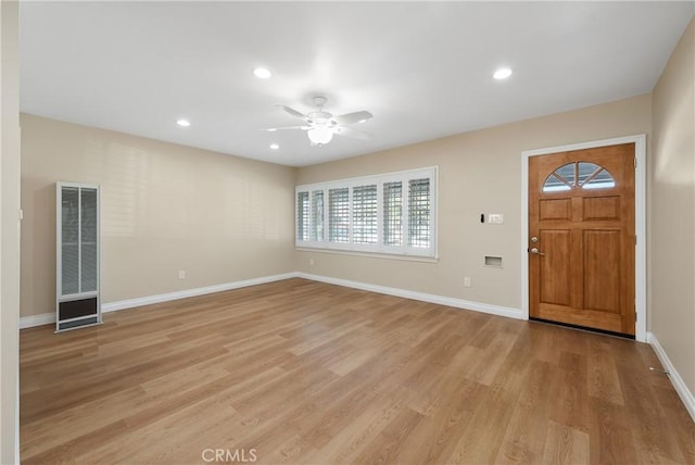 foyer with light hardwood / wood-style floors and ceiling fan