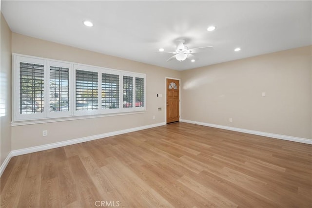 spare room featuring ceiling fan and light hardwood / wood-style flooring