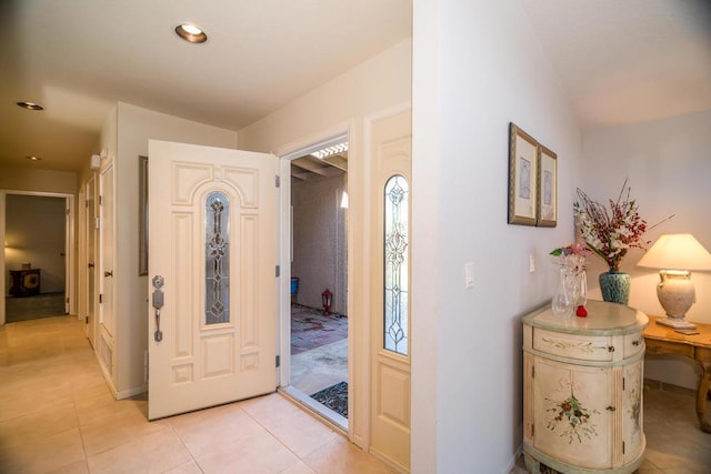 foyer entrance with light tile patterned floors