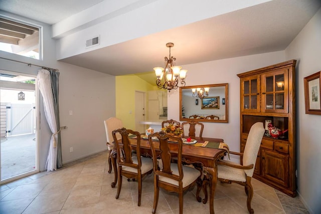 tiled dining space featuring a notable chandelier and vaulted ceiling