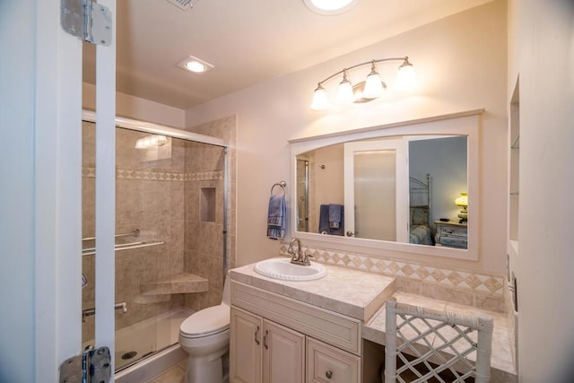 bathroom featuring toilet, walk in shower, and vanity