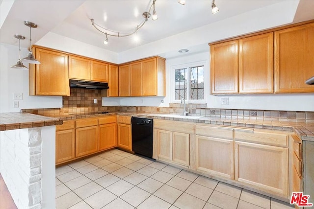 kitchen with sink, black appliances, pendant lighting, tile counters, and light tile patterned flooring