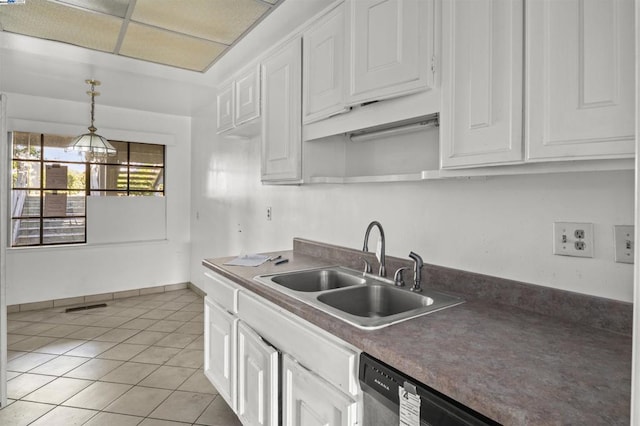 kitchen with white cabinetry, sink, hanging light fixtures, stainless steel dishwasher, and light tile patterned floors