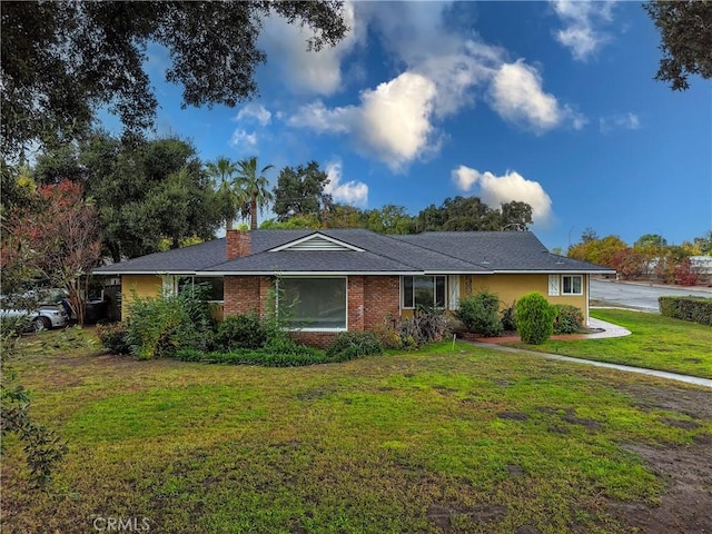 ranch-style home with a front lawn