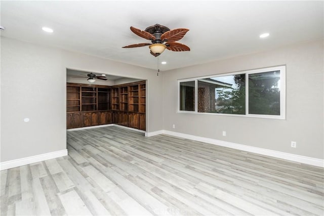 empty room featuring ceiling fan and light hardwood / wood-style flooring