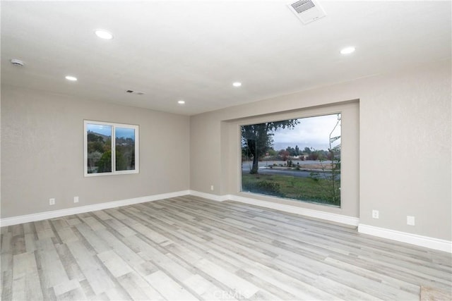 spare room with light hardwood / wood-style floors