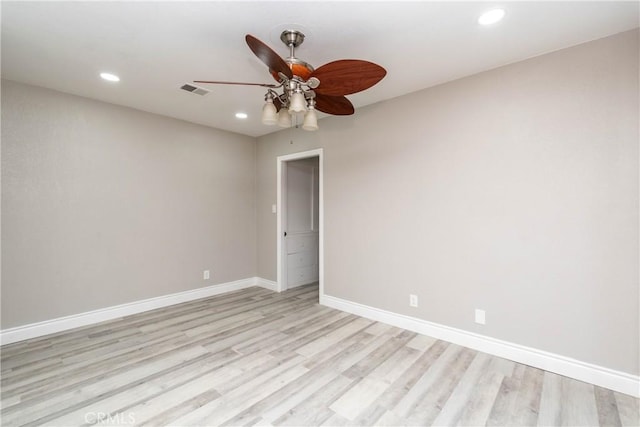 empty room with ceiling fan and light hardwood / wood-style flooring