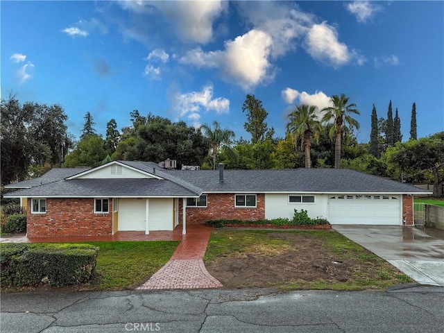 single story home with a garage and a front lawn