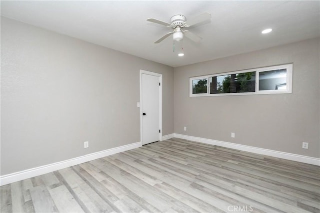 empty room with ceiling fan and light wood-type flooring