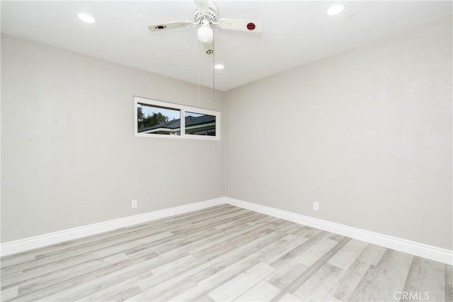 spare room with light hardwood / wood-style floors and ceiling fan