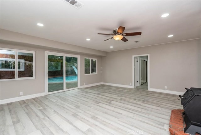 unfurnished living room featuring ceiling fan and light wood-type flooring