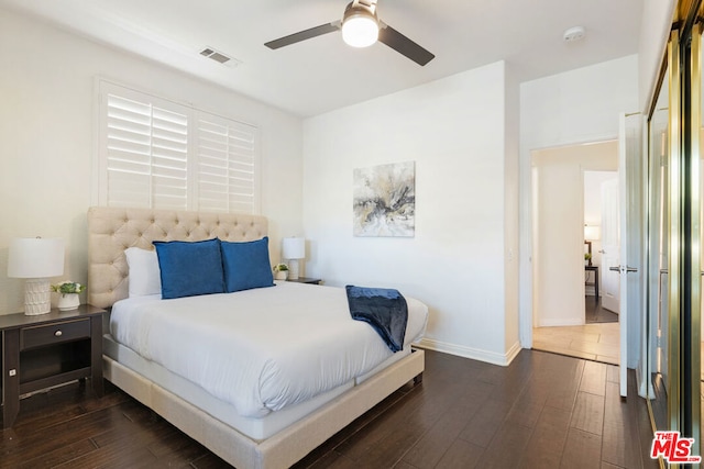 bedroom with ceiling fan and dark hardwood / wood-style flooring