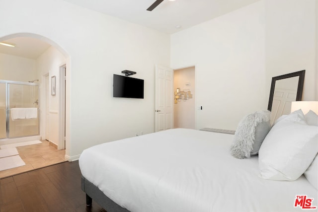 bedroom featuring ensuite bath, ceiling fan, and dark hardwood / wood-style floors