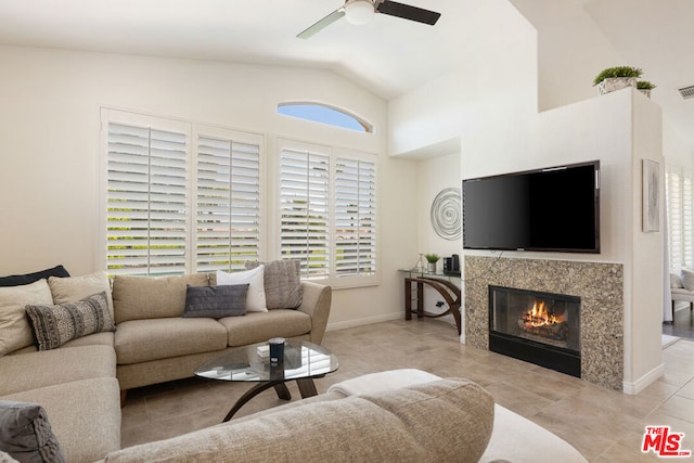 tiled living room with ceiling fan and lofted ceiling