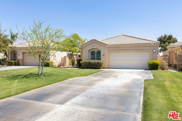 view of front of home with a front yard and a garage