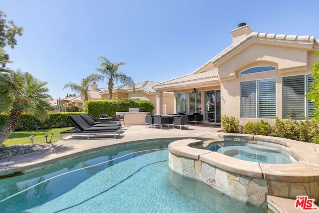 view of swimming pool featuring an in ground hot tub, a patio, and ceiling fan