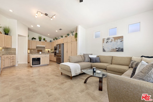 living room with high vaulted ceiling