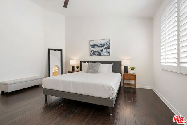 bedroom featuring ceiling fan and dark wood-type flooring