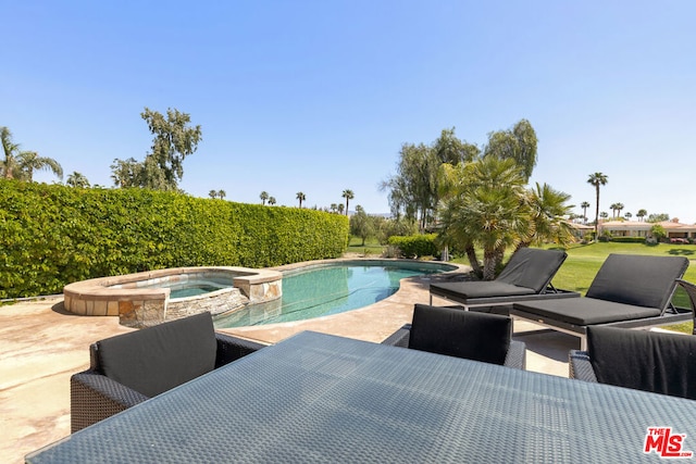 view of pool with a patio area and an in ground hot tub