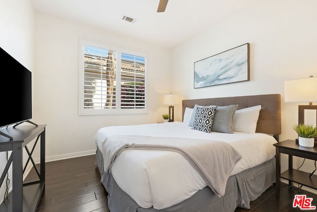 bedroom featuring ceiling fan and dark wood-type flooring