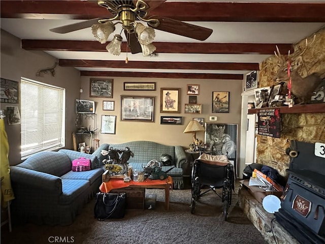 sitting room with ceiling fan, beam ceiling, and carpet floors