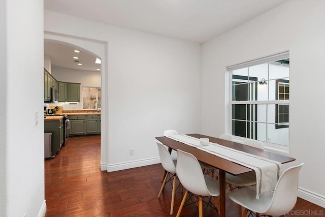 dining room with dark hardwood / wood-style flooring and sink