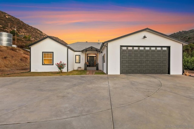 view of front of home featuring a mountain view and a garage