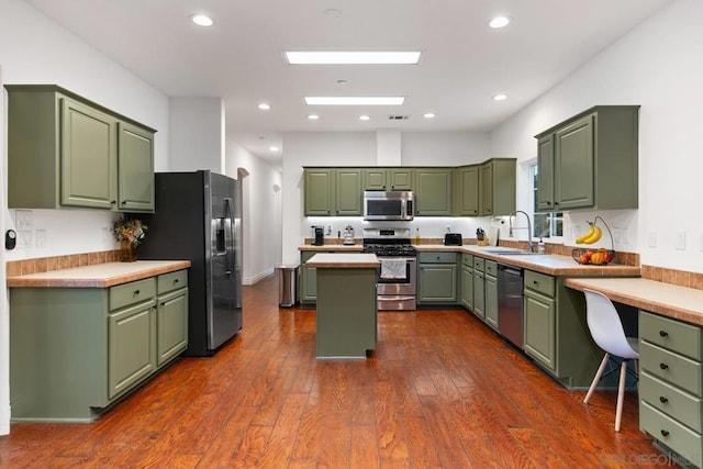 kitchen featuring green cabinets and appliances with stainless steel finishes