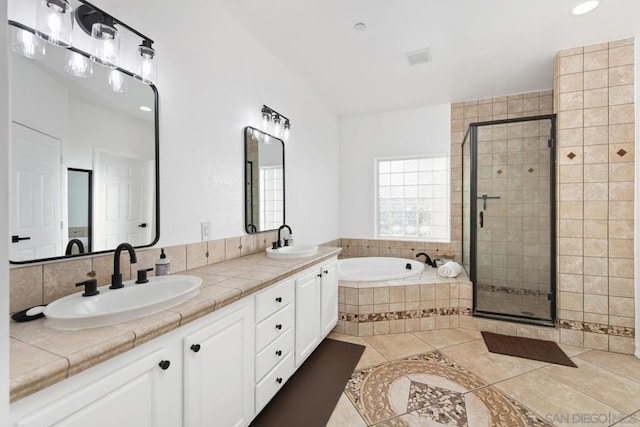 bathroom with tile patterned floors, vanity, and separate shower and tub