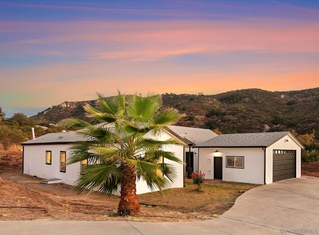 view of front of home featuring a mountain view and a garage