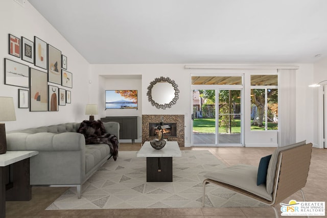 living room with a high end fireplace and light tile patterned floors