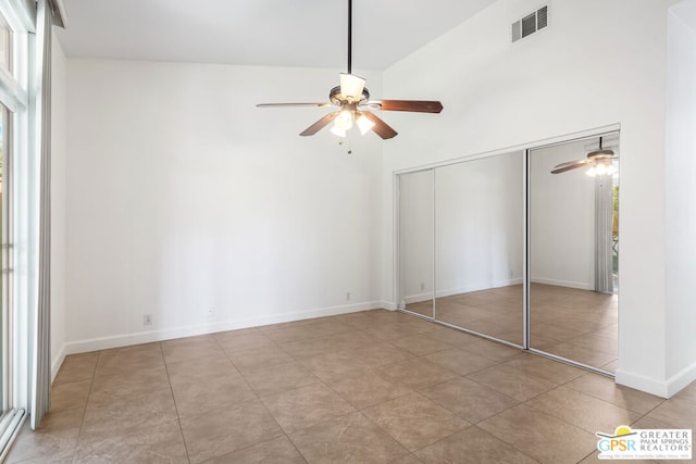 unfurnished bedroom featuring ceiling fan, a closet, and multiple windows