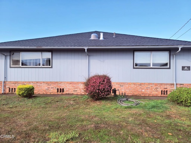 view of side of home featuring a lawn