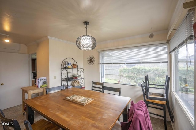 dining space with ornamental molding