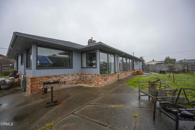 exterior space featuring a lawn and a patio