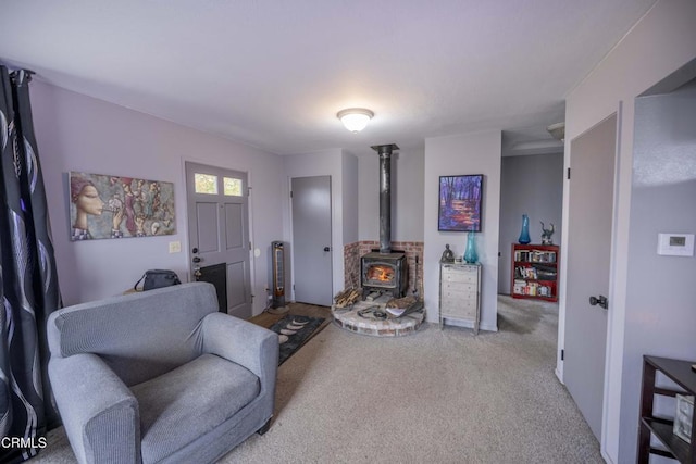 living room featuring a wood stove and light carpet