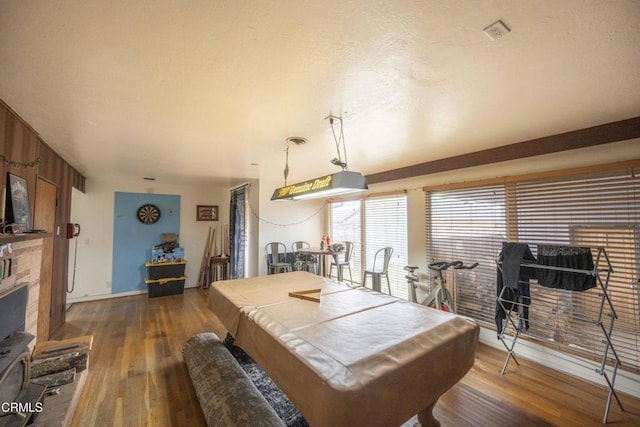 dining area featuring dark hardwood / wood-style flooring, a textured ceiling, and billiards