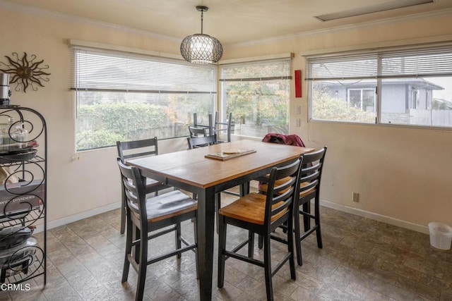 dining space with ornamental molding