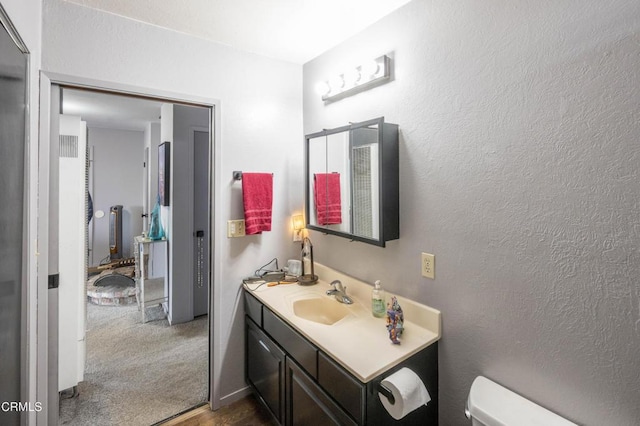 bathroom featuring vanity and toilet