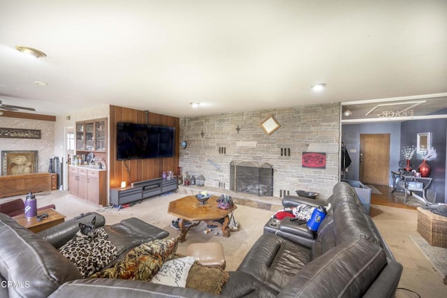 living room with ceiling fan and a fireplace