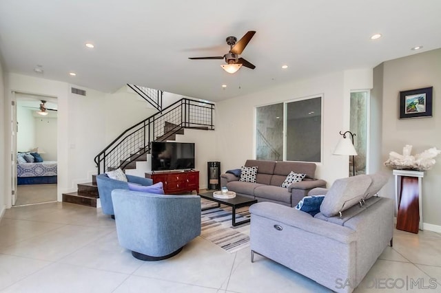 living room with ceiling fan and light tile patterned floors