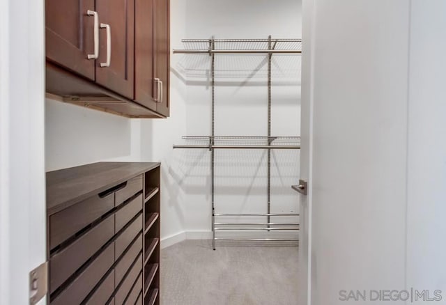 walk in closet featuring carpet