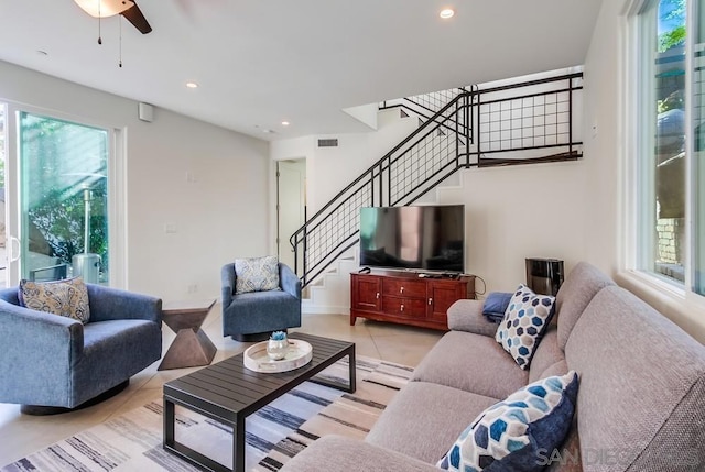 tiled living room featuring ceiling fan