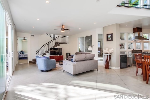 tiled living room featuring a wealth of natural light and ceiling fan